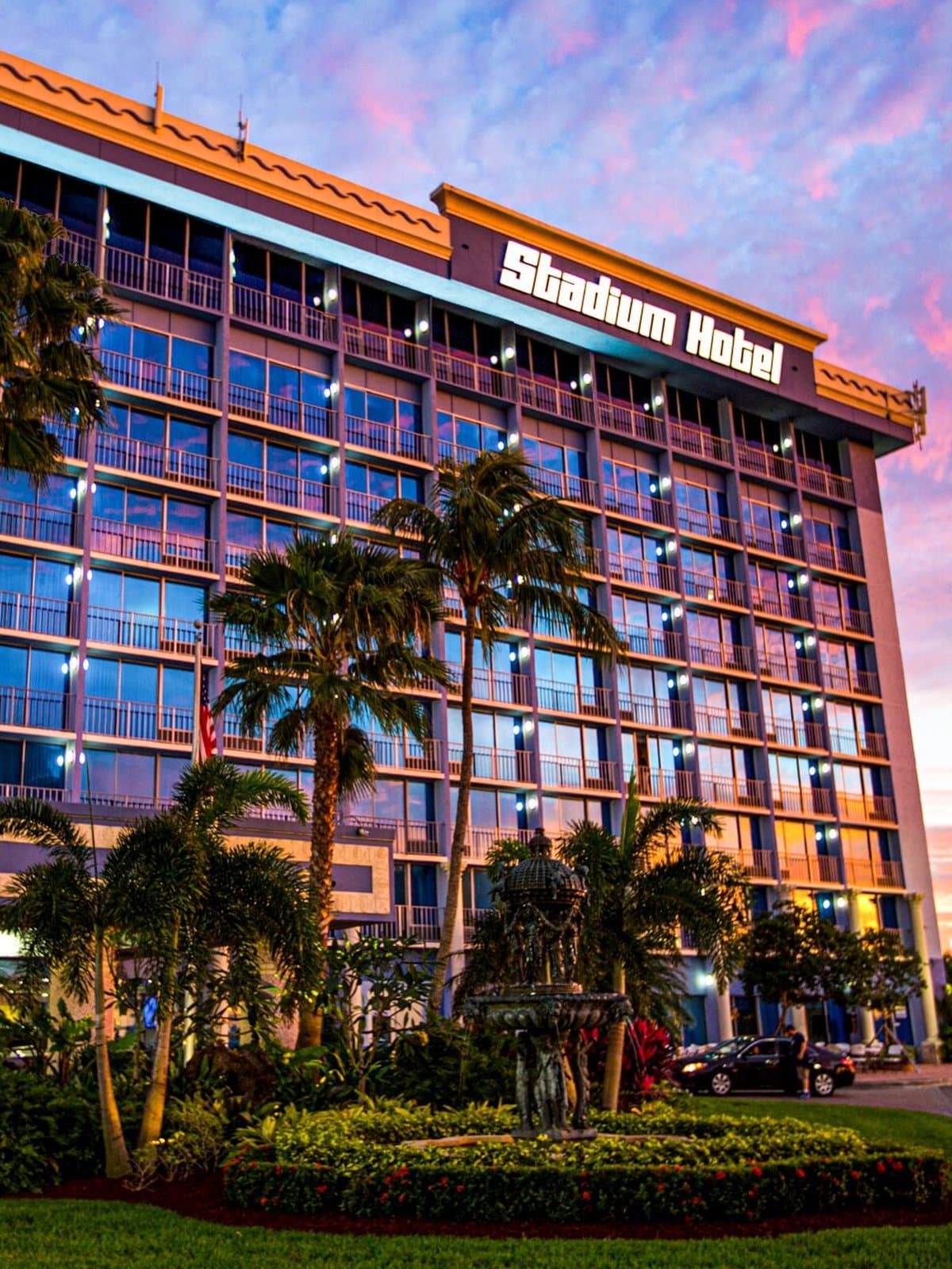 Stadium Hotel under a sunset sky